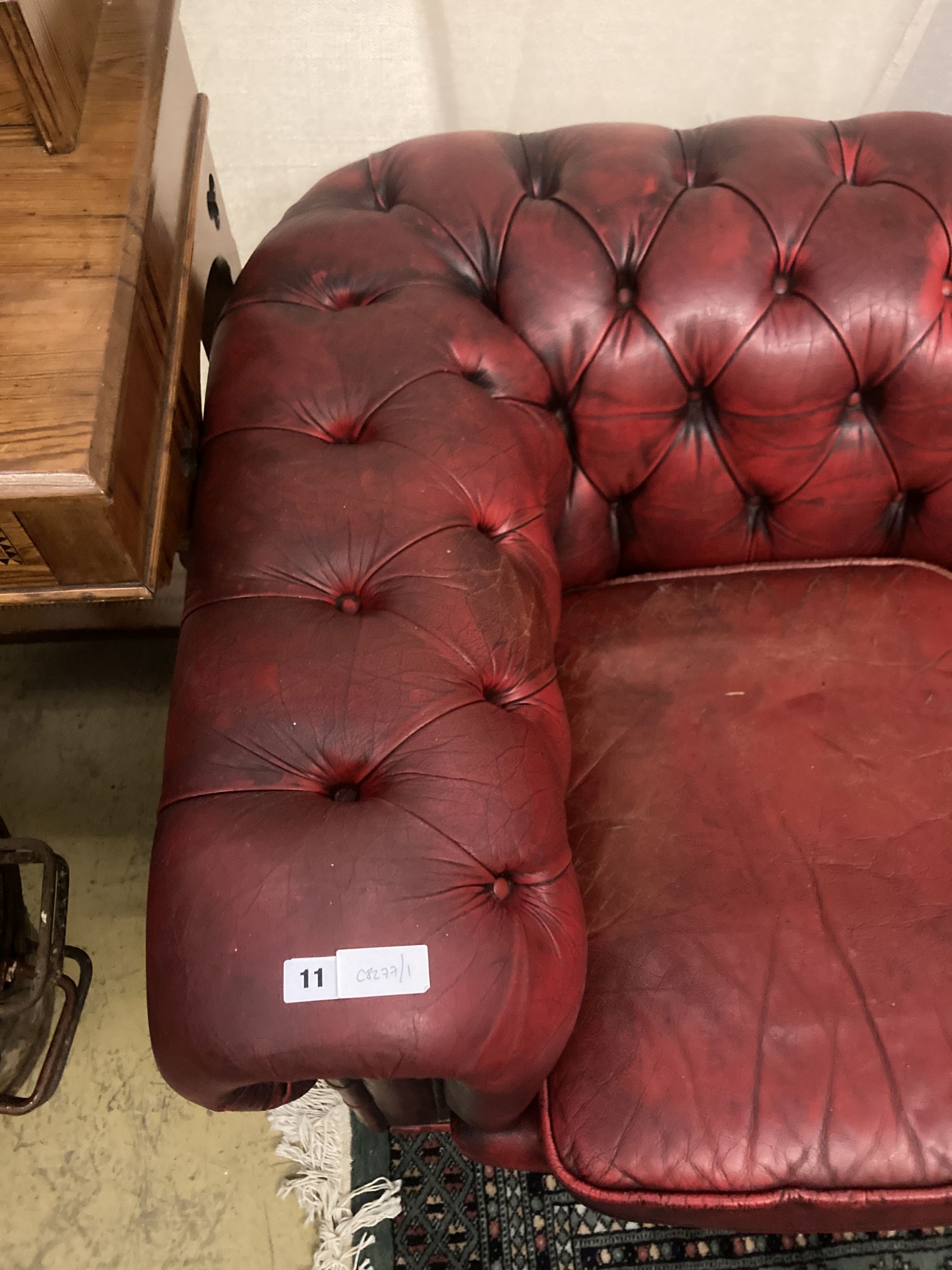 A Victorian style buttoned red leather Chesterfield settee, width 186cm depth 84cm height 66cm